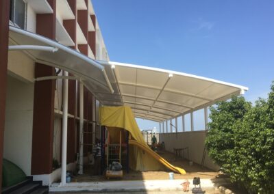 Tensile canopy structures for parking areas with UV protection.